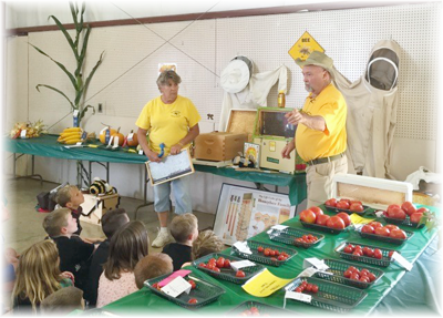 Beth and Rick teaching children about honeybees.